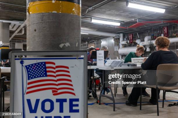 Poll workers process ballots at City Hall on November 05 in Janesville, Wisconsin. Americans cast their ballots today in the presidential race...