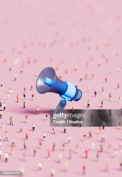large group of people surrounding an oversized megaphone - crowdsourcing imagens e fotografias de stock