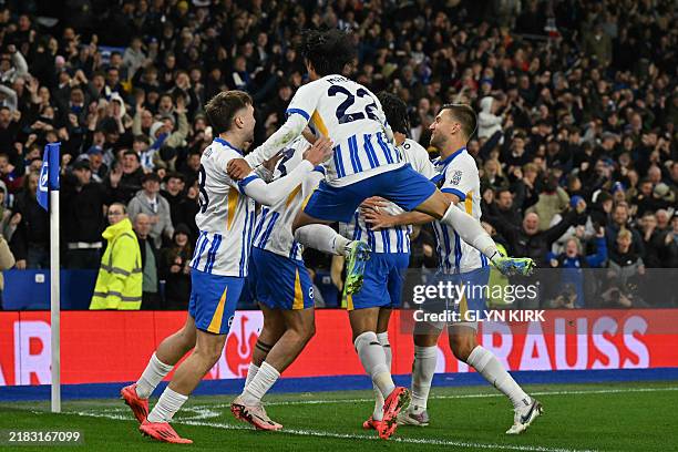 Brighton's English-born Danish midfielder Matt O'Riley celebrates with teammates after scoring their second goal during the English Premier League...