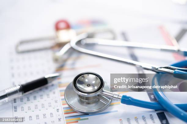stethoscope and charts , saving stack coins money, globe and credit card. finance, account, statistics, investment, analytic research data economy and business company meeting concept. - medicin bildbanksfoton och bilder