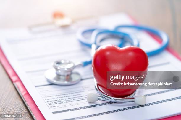 health insurance concept,cost of health care concept, stethoscope and calculator on document - colesterol imagens e fotografias de stock