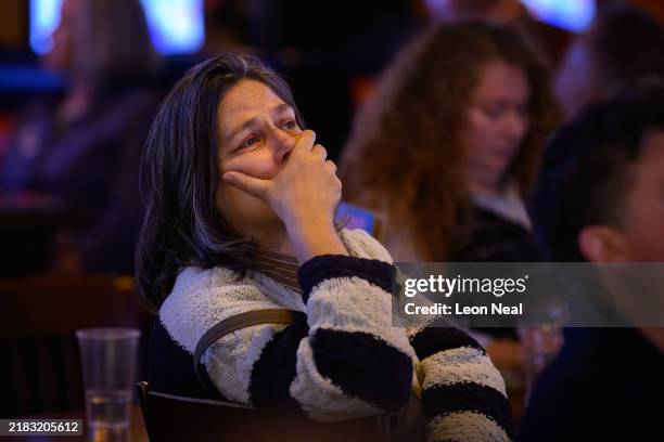 Supporters of Democratic presidential nominee, U.S. Vice President Kamala Harris, react as results are displayed during a "Democrats Abroad" election...