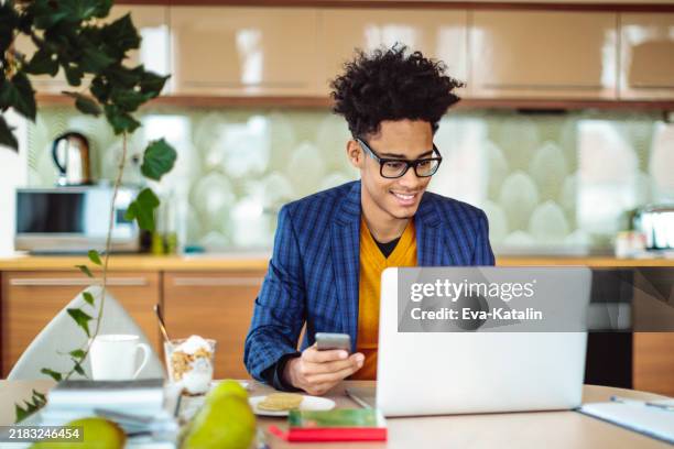 young man is working at home - eva morales stock pictures, royalty-free photos & images