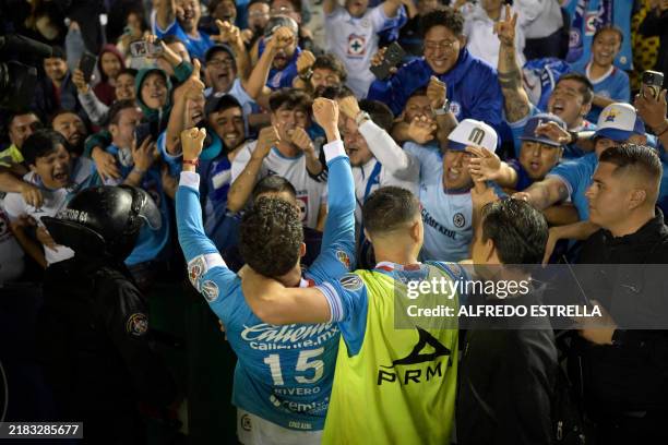 Cruz Azul's players celebrates their goal with their supporters during the Liga MX Apertura tournament football match between Cruz Azul and Tigres at...