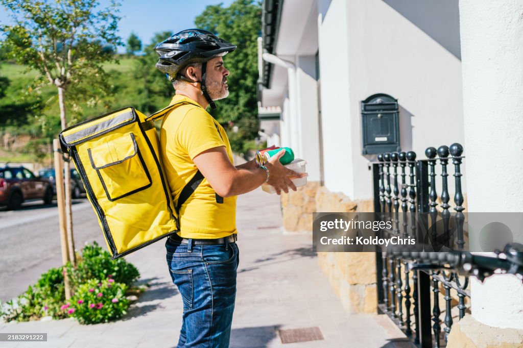 Deliveryman carrying food delivery to a customer's door