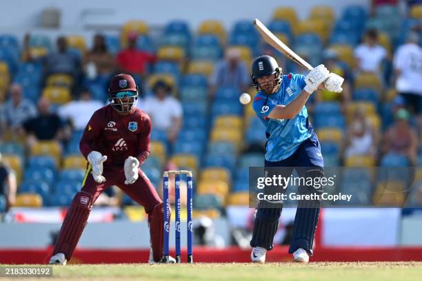 Phil Salt of England bats watched by West Indies wicketkeeper Shai Hope during the 3rd One Day International between the West Indies and England at...