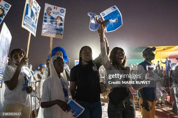 Supporters of the Andu Nawle coalition cheer during a campaign rally in Mbour on November 9 ahead of Senegal's legislative elections on November 17,...