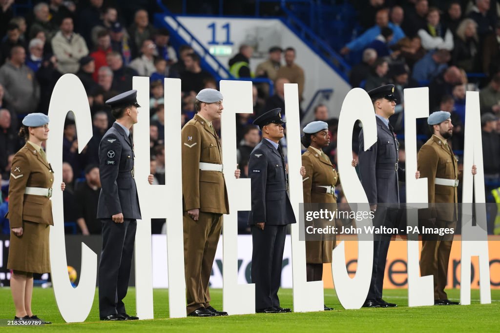 Chelsie Lettering Service members hold up Large Chelsea Lettering during the Premier ...