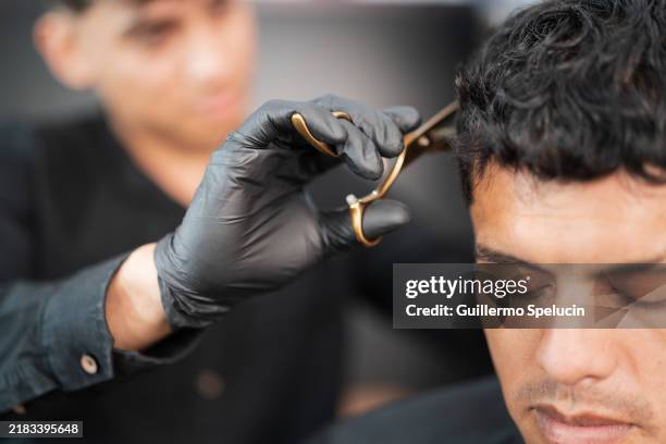 man in the barber shop cutting his hair - mens hair cut stock pictures, royalty-free photos & images