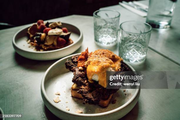 two plates of brunch: savoury choice and sweet choice - honeycomb toffee stock pictures, royalty-free photos & images