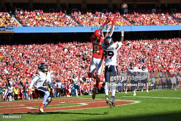 Kansas City Chiefs wide receiver DeAndre Hopkins leaps for a pass against Denver Broncos cornerback Ja'Quan McMillian in the first half on Sunday,...