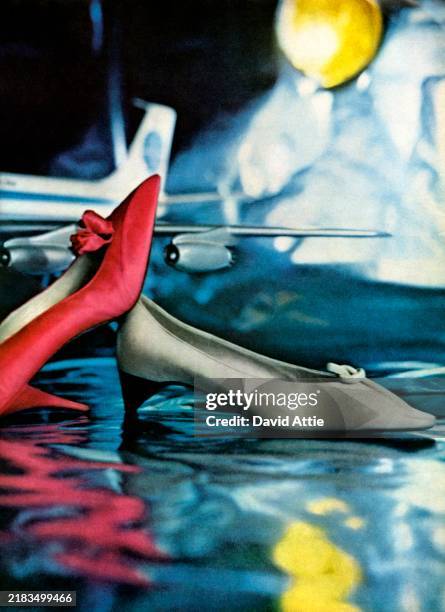 Red silk satin opera pump with a diagonally-planed panel on the right side of the toe, and a silk rosebud at the throat, and a gray calfskin pump...