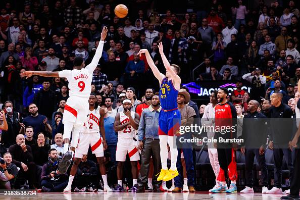Toronto Raptors Bench The Toronto Raptors bench watches as Christian Braun of the Denver ...