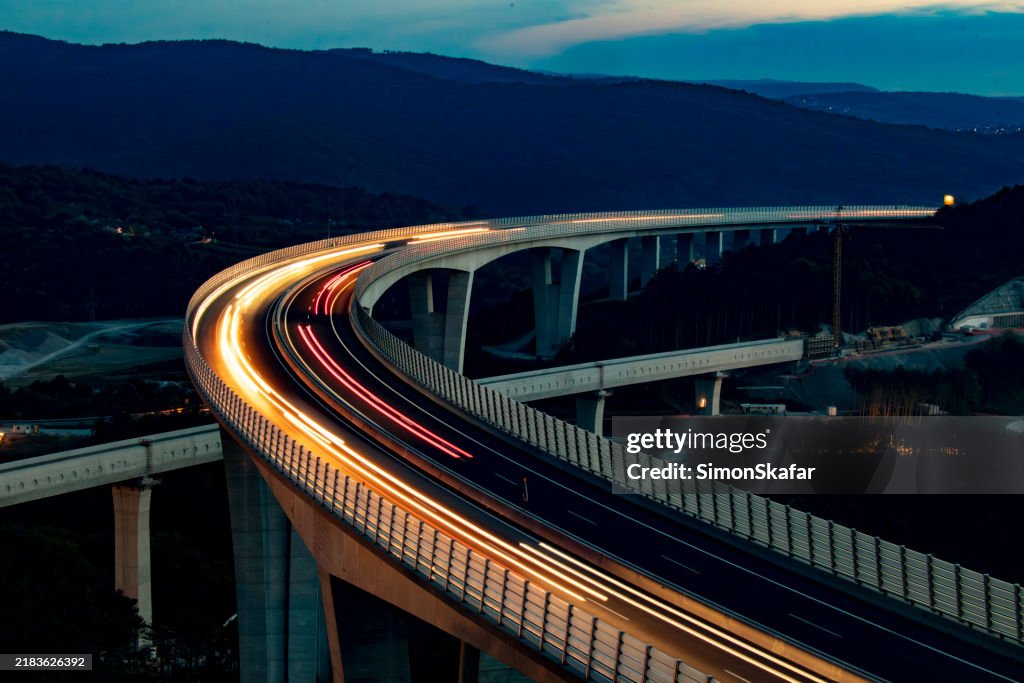Nighttime Traffic Flowing Across Expansive Viaduct