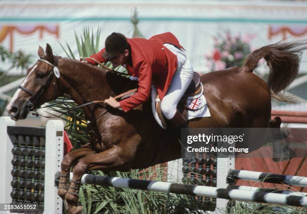 Steven Smith from Great Britain riding his horse Shining Example jumping the fence rail during the Team Show Jumping competition on 7th August 1984...