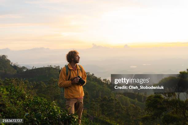 man photographing with camera at tea plantation in sri lanka - hobbies stock pictures, royalty-free photos & images