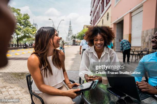 coworkers talking at sidewalk cafe - cali colombia stock pictures, royalty-free photos & images