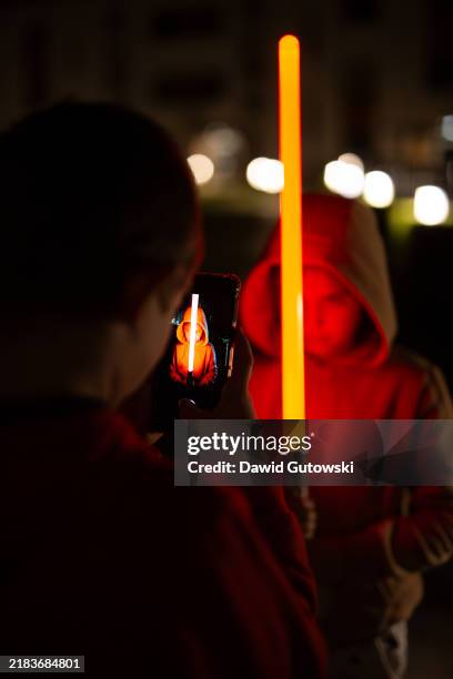 kids recording a light sword movie with a smartphone at night - laser sword stock pictures, royalty-free photos & images