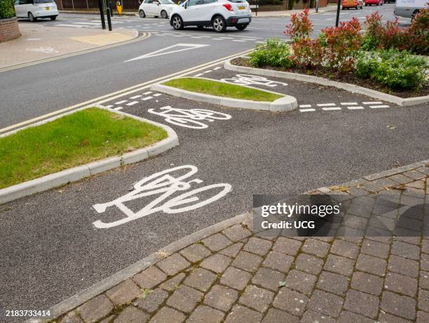 Dedicated bicycle lane to separate bikes from cars at a road junction in Enfield, London, UK.