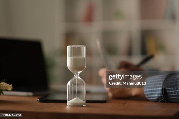 man working over a period of time - ampulheta imagens e fotografias de stock