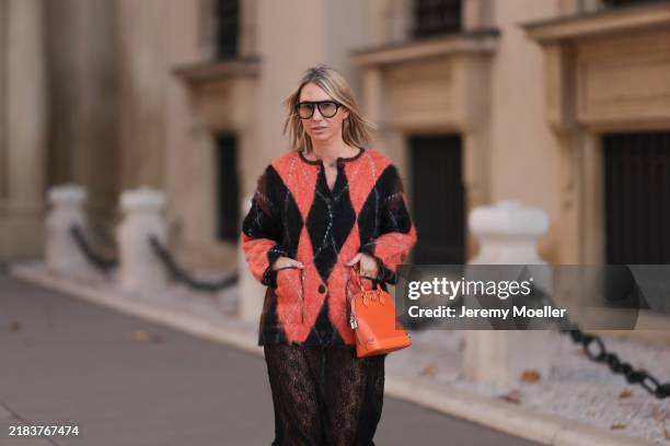 Karin Teigl is seen wearing aviator glasses with a rounded black frame from Andy Wolf; a yellow gold “Alhambra” necklace with a green gemstone...