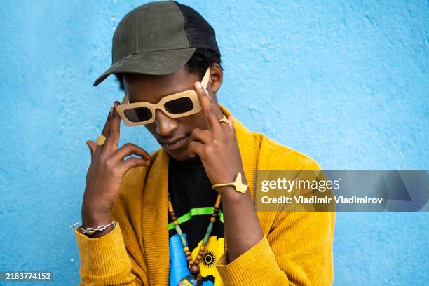 thoughtful looking african man - blue baseball cap stock pictures, royalty-free photos & images