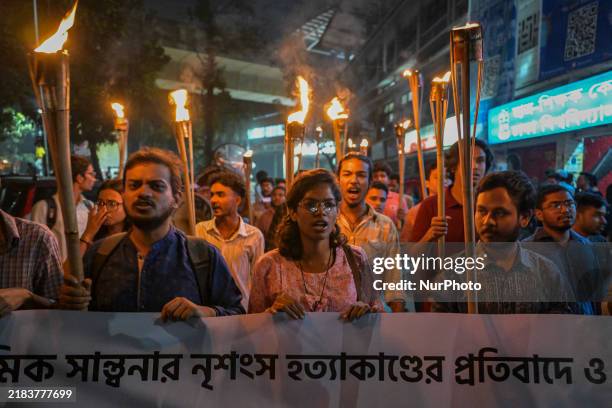 The Bangladesh Students Union holds a torch procession protesting the murder of a female ready-made garment worker and demanding justice in the Dhaka...