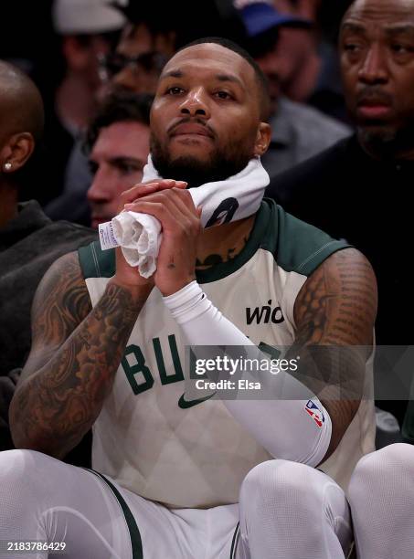 Damian Lillard of the Milwaukee Bucks reacts on the bench in the fourth quarter against the New York Knicks at Madison Square Garden on November 08,...