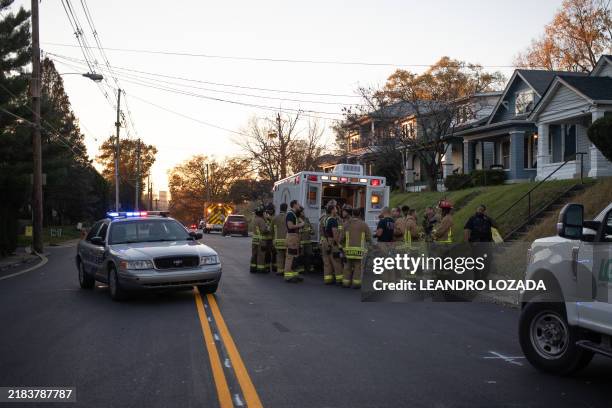 Firefighters gather near an emergency services vehicle after an explosion in the Clifton Neighborhood in Louisville, Kentucky, on November 12, 2024....