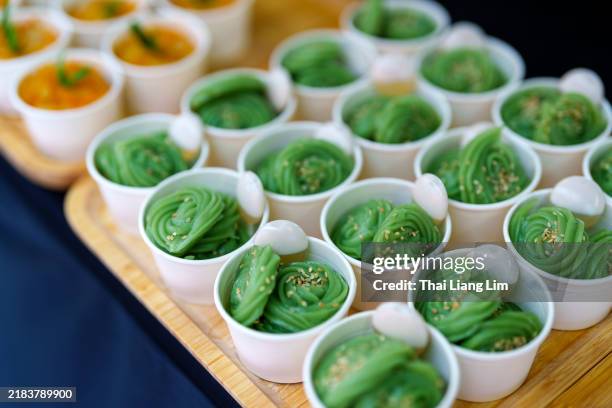 thai pandan-flavored desserts are popular for their unique fragrance and vibrant green color. - food coloring stock pictures, royalty-free photos & images