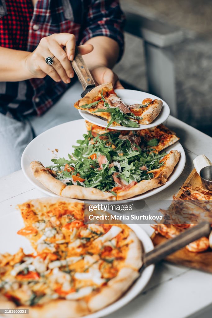 Delicious homemade pizza with fresh arugula and tomato toppings for a casual dining experience.