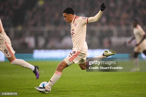 Jamal Musiala of Bayern Munich scores his team's first goal during the Bundesliga match between FC St. Pauli 1910 and FC Bayern München at Millerntor...