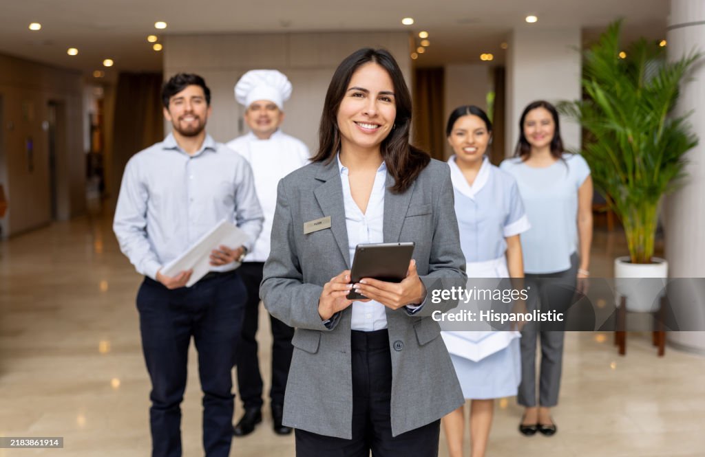 Hotel manager leading a group of employees at the lobby