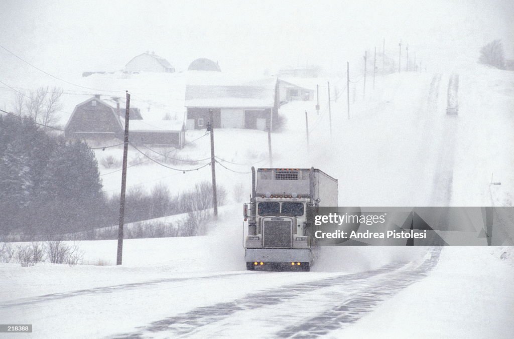 TRUCK ON SNOW-COVERED COUNTRY ROAD