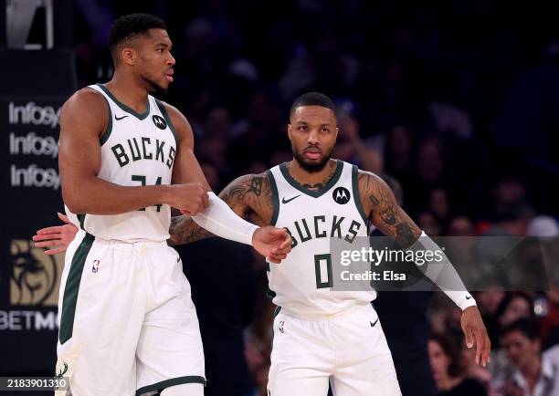 Giannis Antetokounmpo and Damian Lillard of the Milwaukee Bucks prepare for the opening tipoff against the New York Knicks at Madison Square Garden...