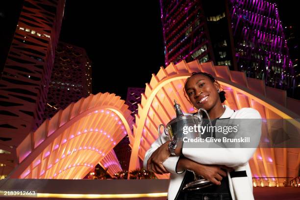 Coco Gauff of the United States holds the Billie Jean King Trophy in front of the King Abdullah Financial District after her three set victory...