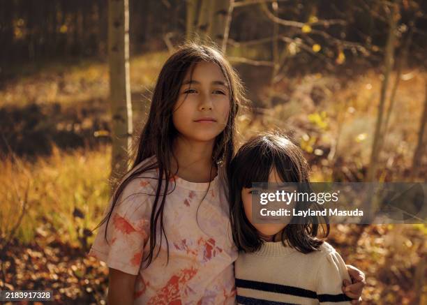 sisters enjoy fall weather outdoors - common aspen tree stock pictures, royalty-free photos & images