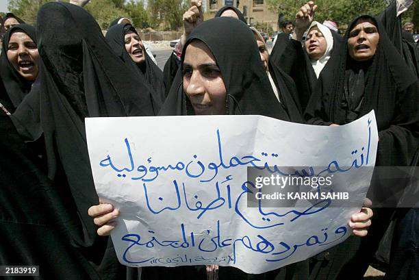 Iraqi teachers and professors demonstrate against what they say is their unfair dismissal by US-led occupation forces 20 July 2003 in Baghdad. The...