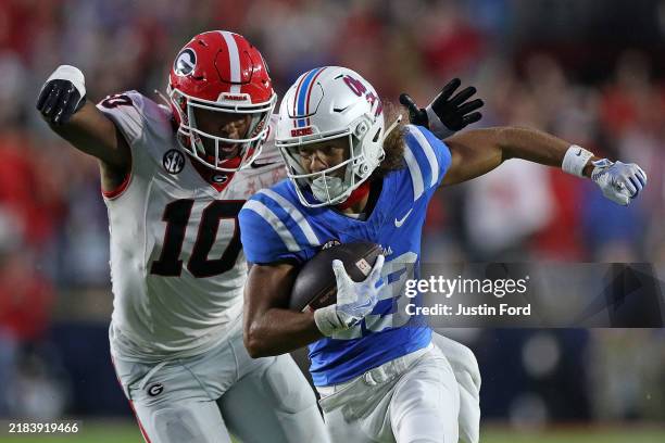 Cayden Lee of the Mississippi Rebels carries the ball against Damon Wilson II of the Georgia Bulldogs during the second half at Vaught-Hemingway...