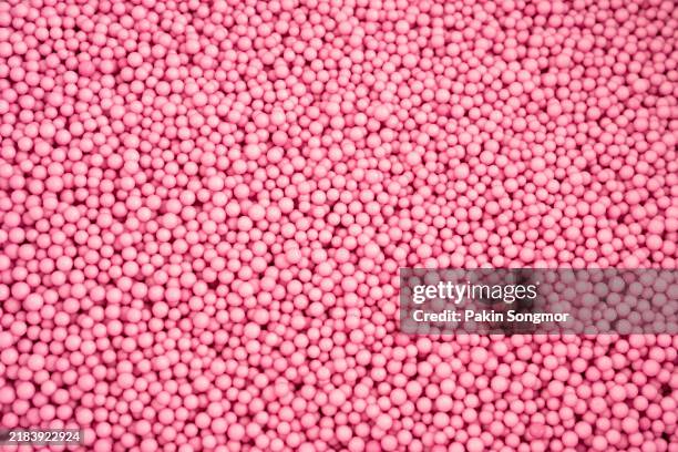close-up foam beads or polystyrene balls red color texture as background. - perlenschmuck stock-fotos und bilder
