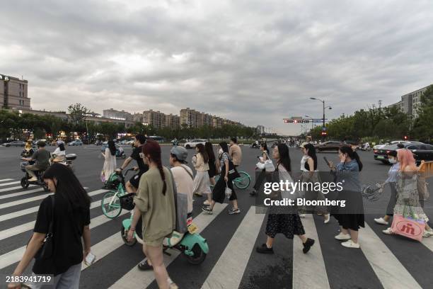 Pedestrians cross a road near the Alibaba Group Holding Ltd. Headquarters in Hangzhou, China, on Monday, June 19, 2023. Halfway through 2023, China...