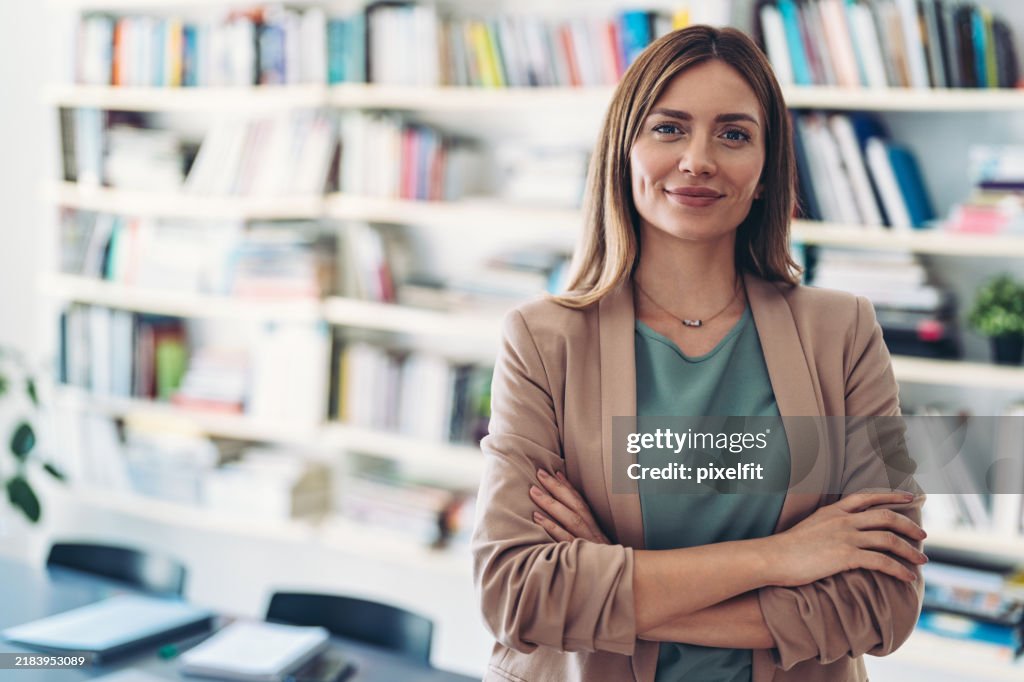 Portrait of a smiling woman in front of a library