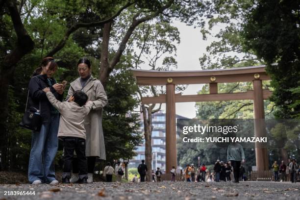 People visit the Meiji shrine in Tokyo on November 14, 2024. A 65-year-old American tourist was arrested for allegedly etching letters onto a...