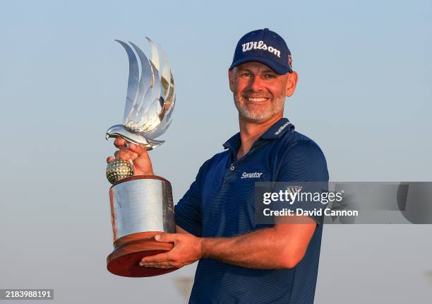 Paul Waring of England holds the trophy after his win in the final round of the Abu Dhabi HSBC Championship 2024 at Yas Links Golf Course on November...