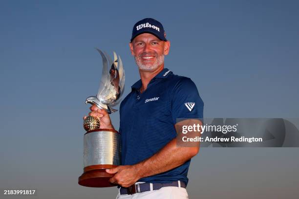Paul Waring of England poses with the trophy on the 18th green on day four of the Abu Dhabi HSBC Championship 2024 at Yas Links Golf Course on...