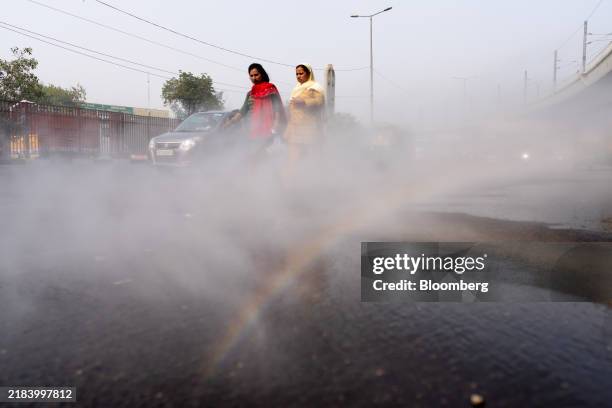 Vehicle sprays water onto the road for dust suppression during severe air pollution in New Delhi, India, on Thursday, Nov. 14, 2024. Nearly half the...