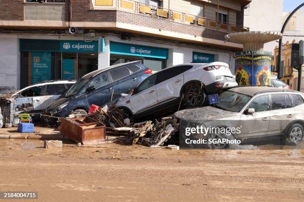the resulting effect of a dana storm. cars and other vehicles stacked upturned as effects of torrential flood in valencia, spain - comunidad autonoma de valencia stock pictures, royalty-free photos & images