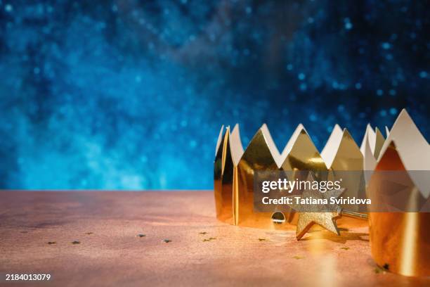 crowns and star wand on table with dark blue background - epiphany stock pictures, royalty-free photos & images