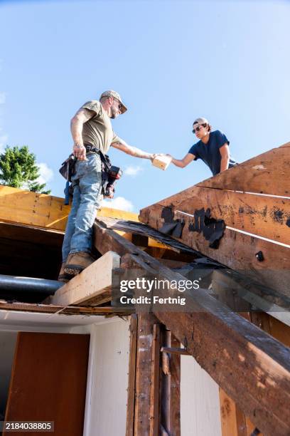 an old house being renovated - dakdekker stockfoto's en -beelden