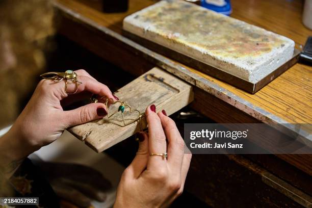 jeweler creating handmade gold jewelry with gemstones in workshop - juwelier stockfoto's en -beelden